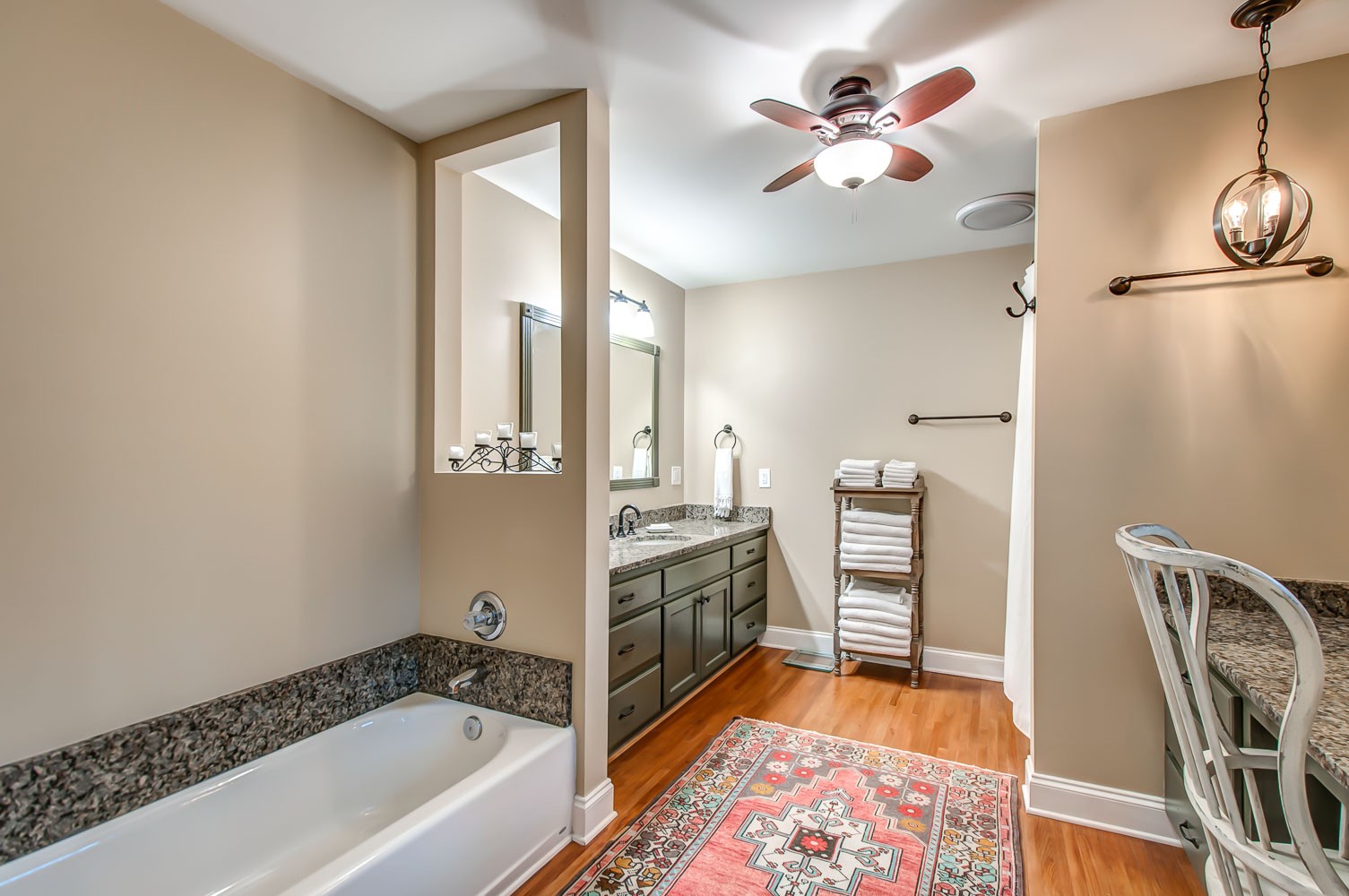 5934 Garrison Road Franklin, TN 37064 - Photo 28 of 39 a bathroom with a tub a sink and a chandelier