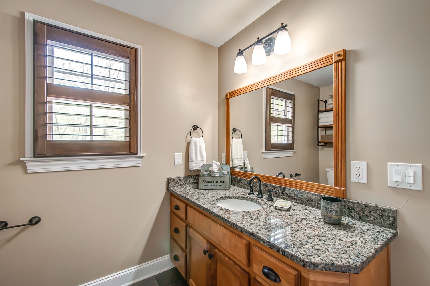 5934 Garrison Road Franklin, TN 37064 - Photo 37 of 39 a bathroom with a granite countertop sink and a mirror