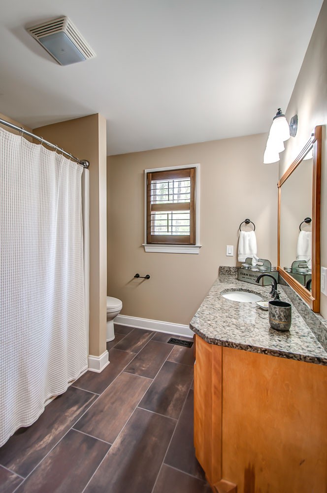 5934 Garrison Road Franklin, TN 37064 - Photo 39 of 39 a bathroom with a granite countertop sink and a mirror