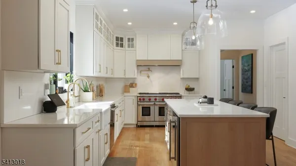 a kitchen with stainless steel appliances a sink a counter top space and a window