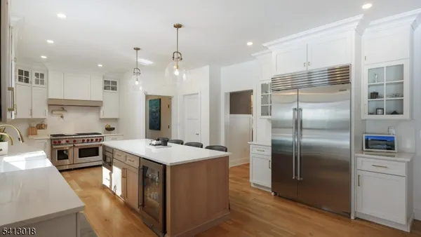 a kitchen with a sink a stove a refrigerator and cabinets