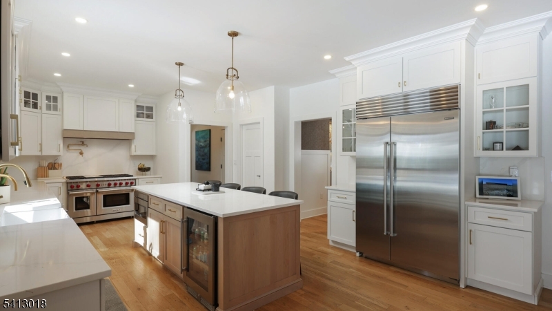 1613 Rising Way Westfield, NJ 07090 - Photo 19 of 50 a kitchen with stainless steel appliances granite countertop a refrigerator a sink a stove a oven a dining table and chairs with wooden floor