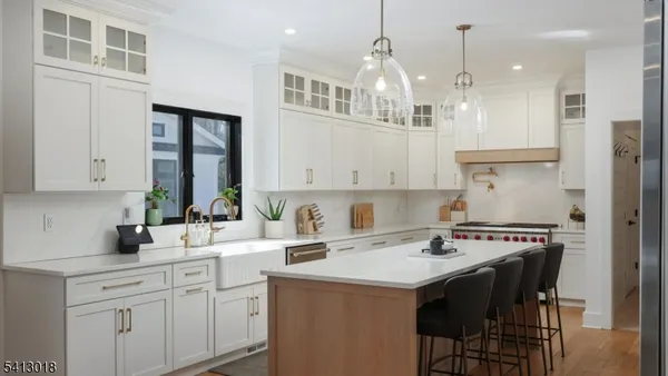 a kitchen with granite countertop white cabinets and stainless steel appliances