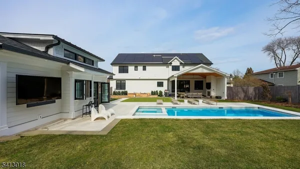 a view of a house with swimming pool and sitting area