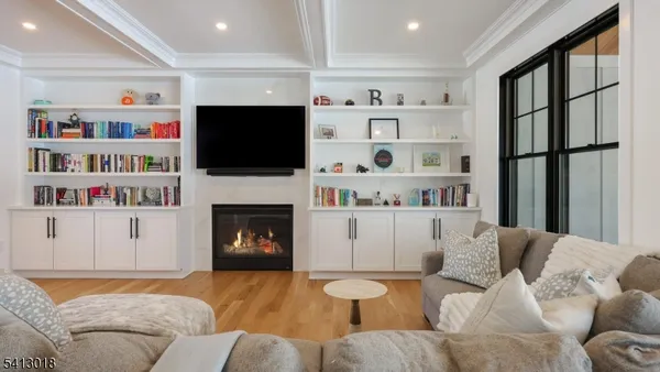 a living room with furniture fireplace and flat screen tv