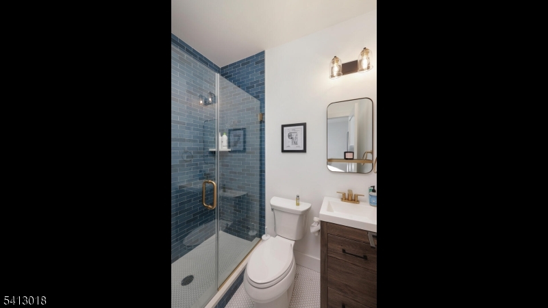 1613 Rising Way Westfield, NJ 07090 - Photo 31 of 50 a white toilet sitting next to a bathroom sink and a toilet