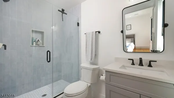 a bathroom with a sink a toilet and mirror