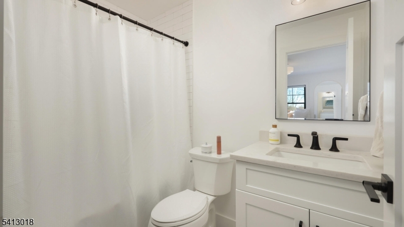 1613 Rising Way Westfield, NJ 07090 - Photo 41 of 50 a bathroom with a sink a toilet and mirror