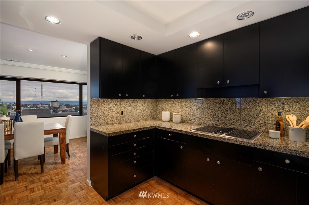 1301 Spring Street, Unit 20G Seattle, WA 98104 - Photo 5 of 24 a kitchen with a sink and a stove top oven
