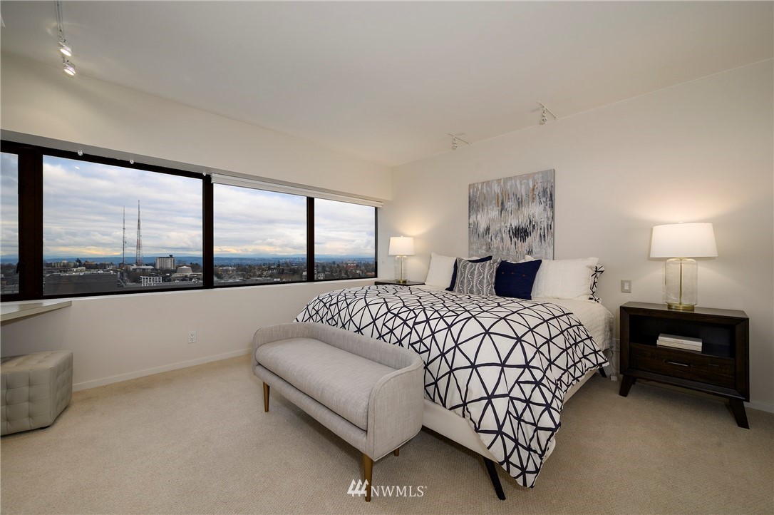 1301 Spring Street, Unit 20G Seattle, WA 98104 - Photo 6 of 24 a bedroom with a large bed and a large window