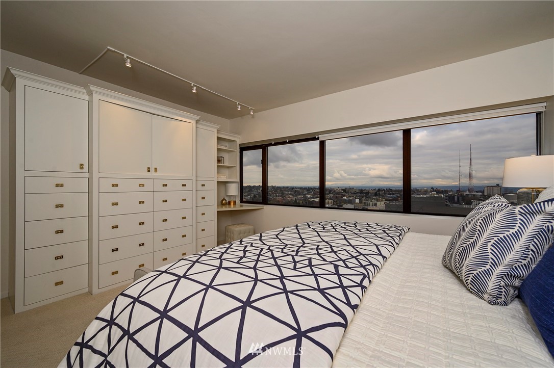 1301 Spring Street, Unit 20G Seattle, WA 98104 - Photo 7 of 24 a bed sitting in a bedroom next to a window
