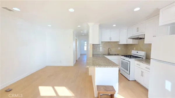 a kitchen with a stove a sink and a refrigerator