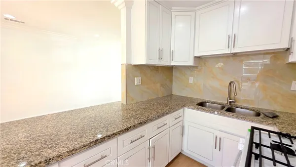 a view of a kitchen cabinets and a counter place