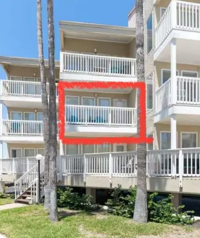 a front view of a house with a yard and plants