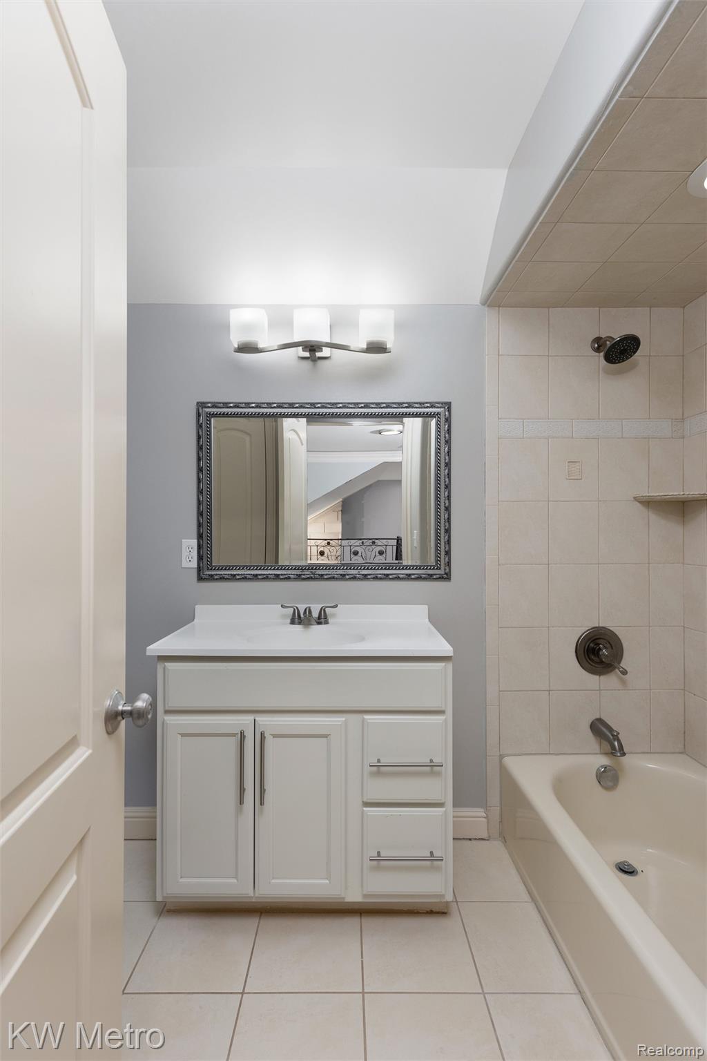 65884 Windrose Court Ray, MI 48096 - Photo 70 of 82 Full bathroom featuring vanity, light tile patterned floors, and tub / shower combination