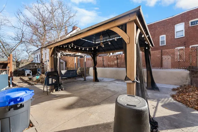 a view of a house with backyard and sitting area