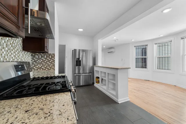 a kitchen with a refrigerator and a stove top oven