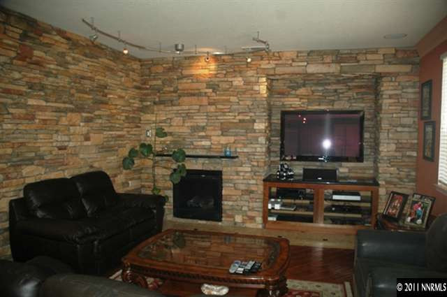 10760 Copper Lake Drive Reno, NV 89521 - Photo 3 of 8 a living room with fireplace furniture and a flat screen tv