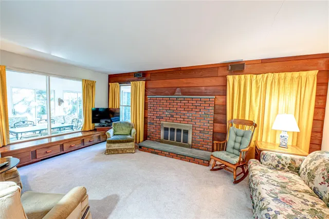 a living room with furniture and floor to ceiling windows