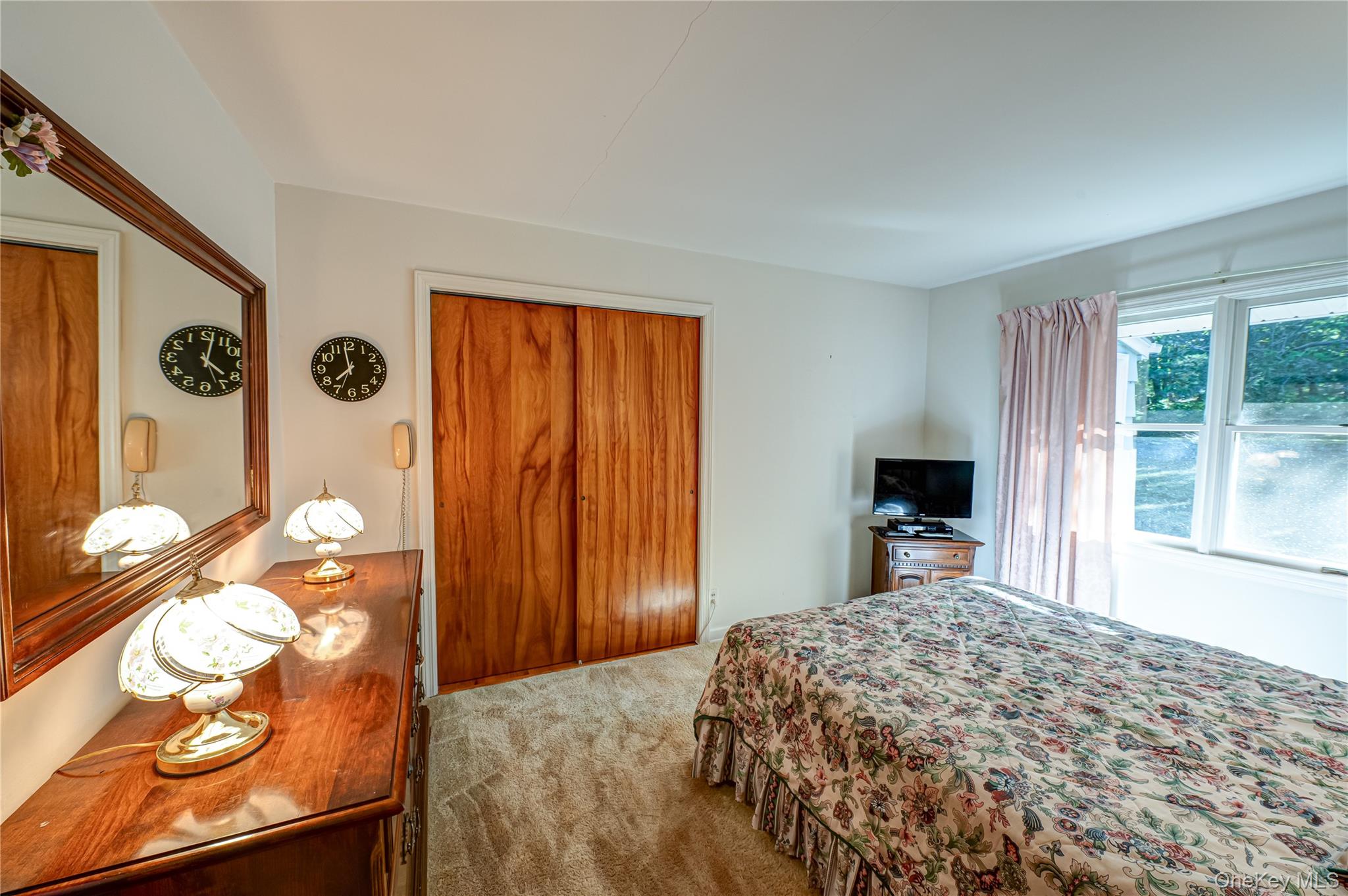 562 Old Bridge Road Northport, NY 11768 - Photo 14 of 25 a bedroom with a bed and dresser with mirror