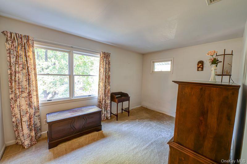 562 Old Bridge Road Northport, NY 11768 - Photo 16 of 25 a bedroom with window and a dresser