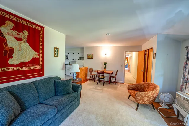 a view of a kitchen with fridge and wooden floor