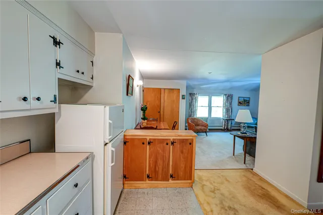 a bathroom with a granite countertop sink and a large mirror