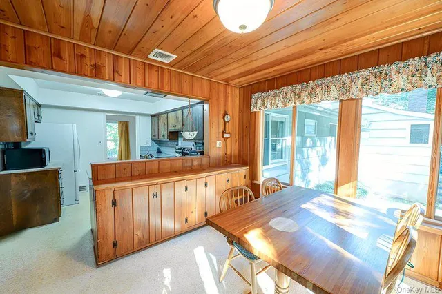 a dining room with furniture wooden floor and outer view