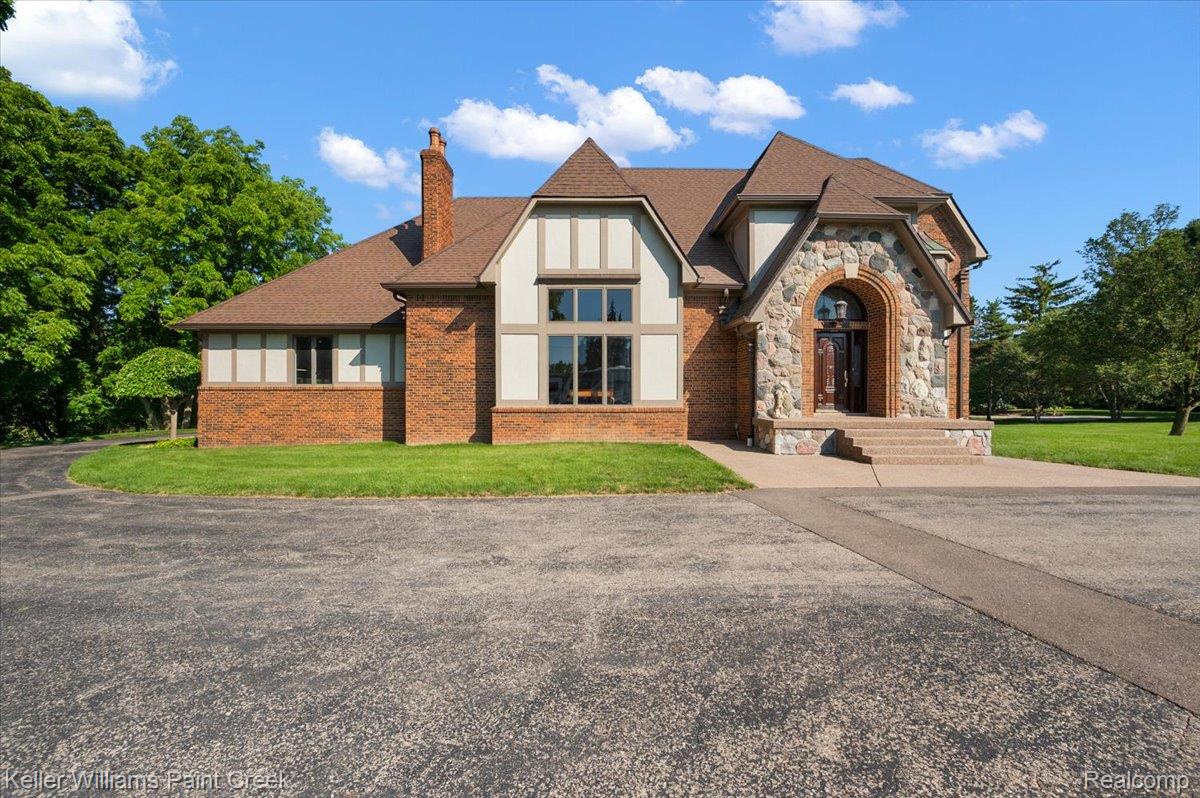 69069 Campground Road Romeo, MI 48065 - Photo 2 of 78 Brick and stone facade residence featuring a prominent arched entryway