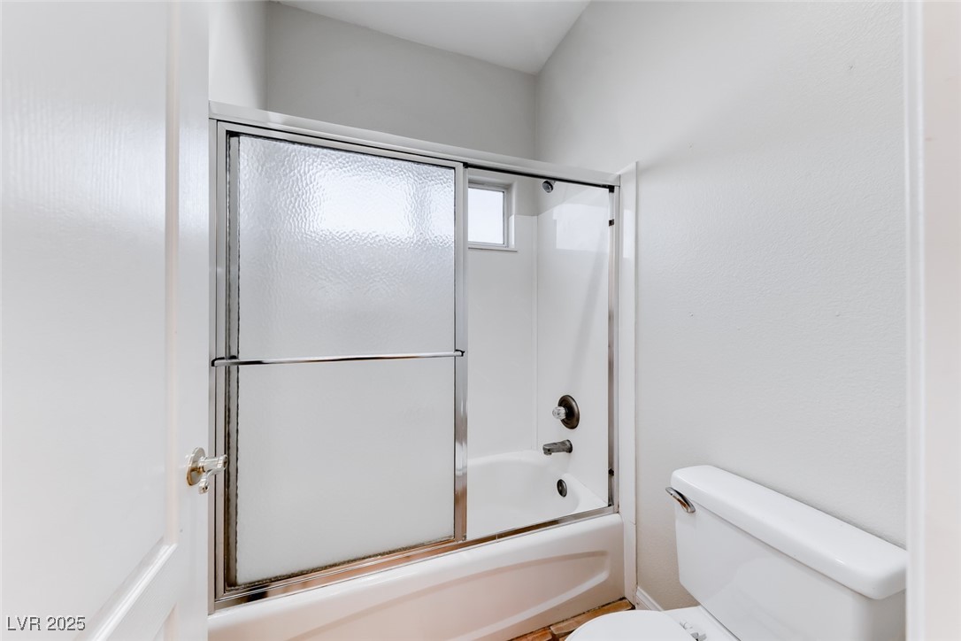 698 Magic Cove Court Boulder City, NV 89005 - Photo 13 of 41 Bathroom with toilet and shower / bath combination with glass door