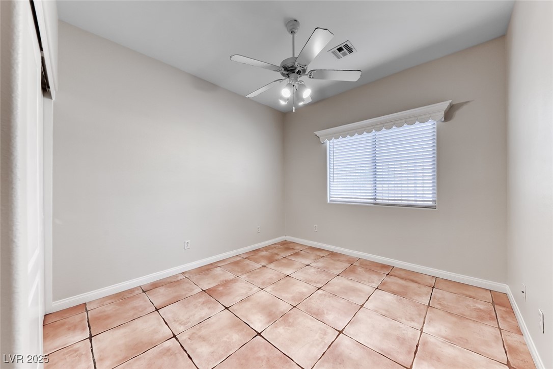 698 Magic Cove Court Boulder City, NV 89005 - Photo 15 of 41 Spare room featuring light tile patterned floors and a ceiling fan