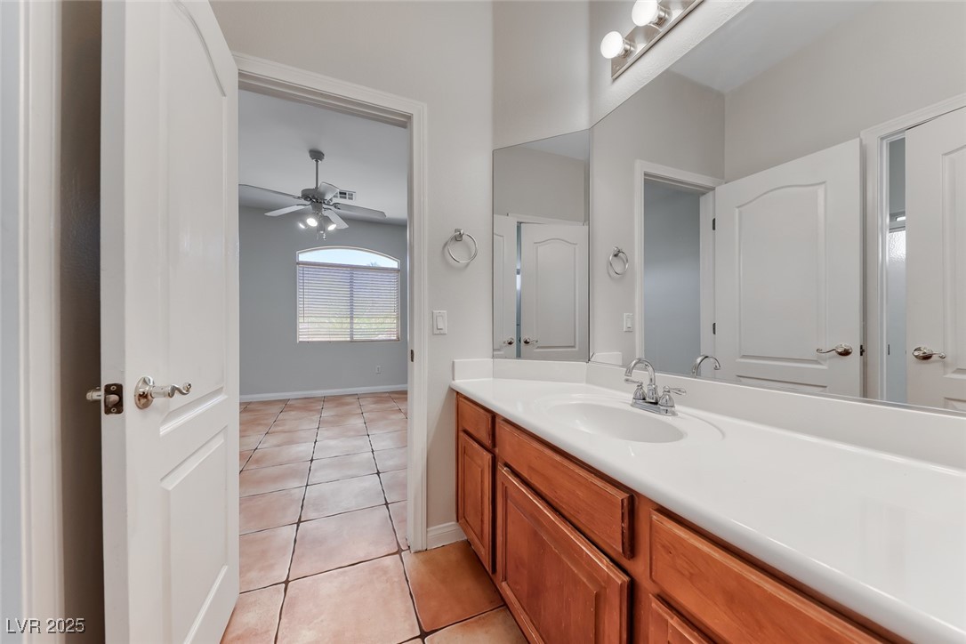 698 Magic Cove Court Boulder City, NV 89005 - Photo 16 of 41 Bathroom with vanity, light tile patterned floors, and a ceiling fan