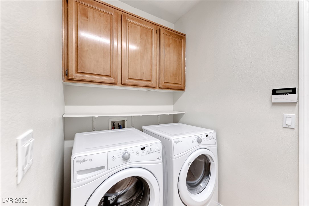 698 Magic Cove Court Boulder City, NV 89005 - Photo 17 of 41 Washroom featuring cabinet space, washing machine and clothes dryer, and a textured wall