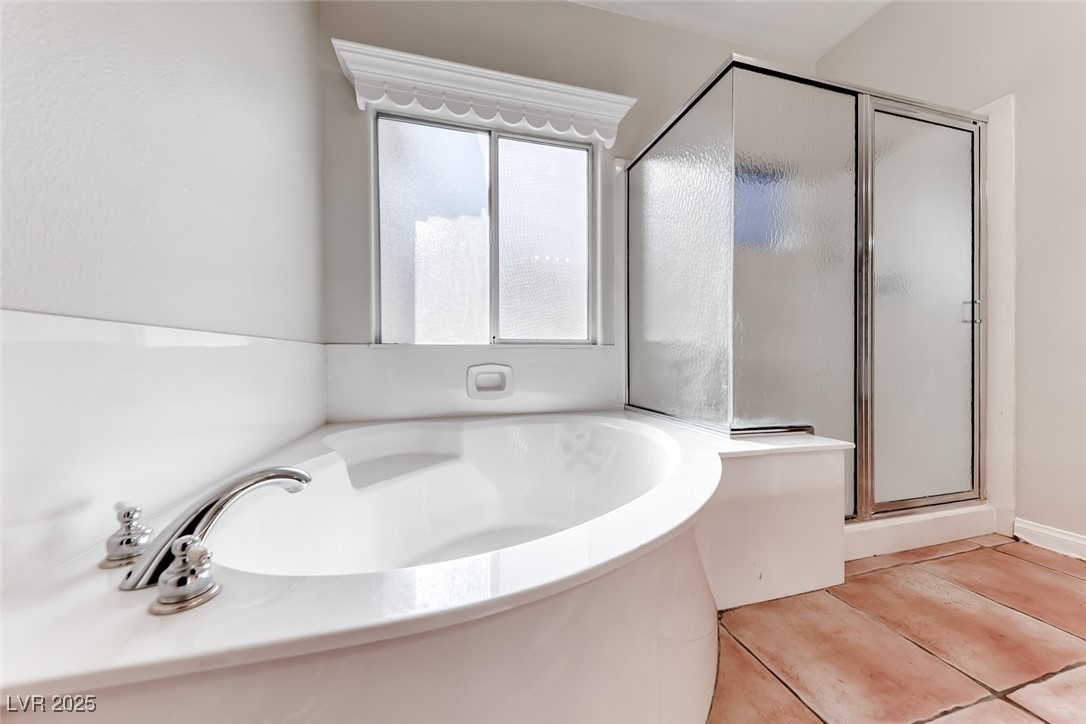 698 Magic Cove Court Boulder City, NV 89005 - Photo 24 of 41 Full bath with a garden tub, a shower stall, and tile patterned flooring