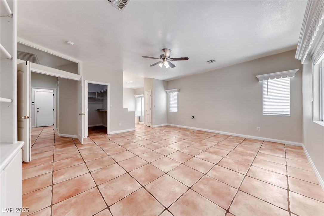 698 Magic Cove Court Boulder City, NV 89005 - Photo 25 of 41 Unfurnished living room featuring light tile patterned floors and a ceiling fan