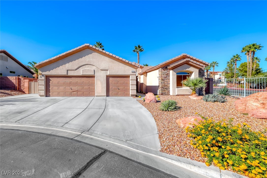 698 Magic Cove Court Boulder City, NV 89005 - Photo 35 of 41 View of front of house featuring stucco siding, concrete driveway, stone siding, and a tiled roof