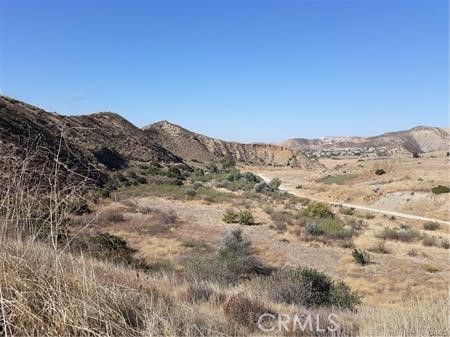 87 Crown Hill Drive Simi Valley, CA 93063 - Photo 2 of 5 a view of a dry yard with mountains in the background