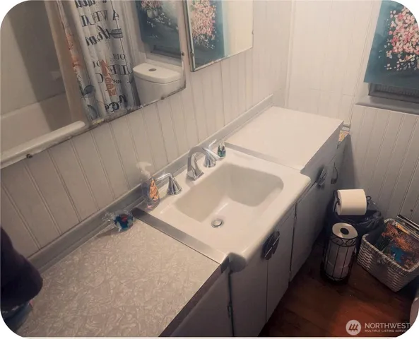 a bathroom with a toilet and a shower curtain