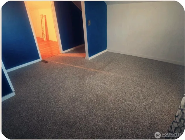 a bedroom with a bed and a chair