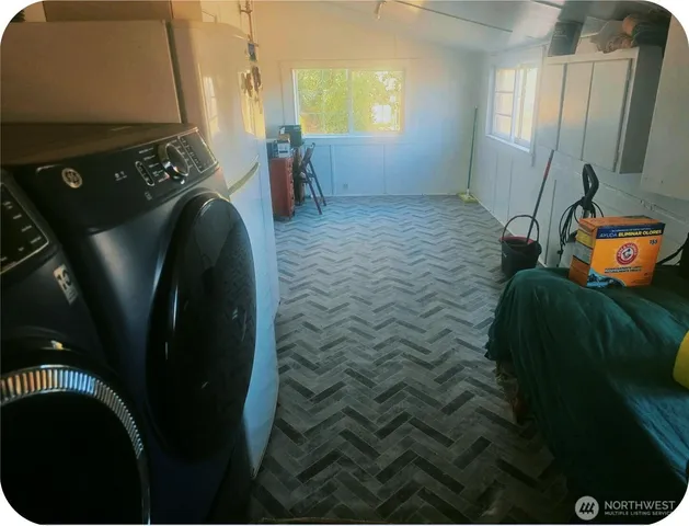 a bed sitting in a bedroom next to a window