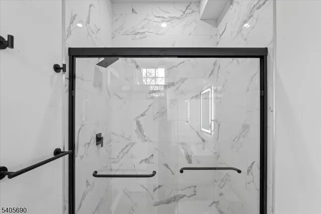 a bathroom with a glass shower door