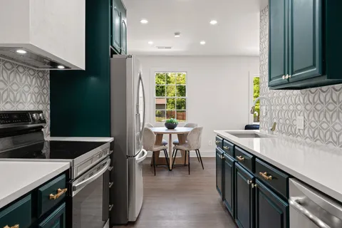 a kitchen with a sink and a stove top oven