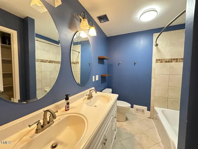 a bathroom with a tub mirror and sink