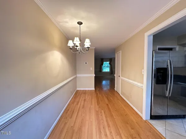 a view of a bedroom with wooden floor