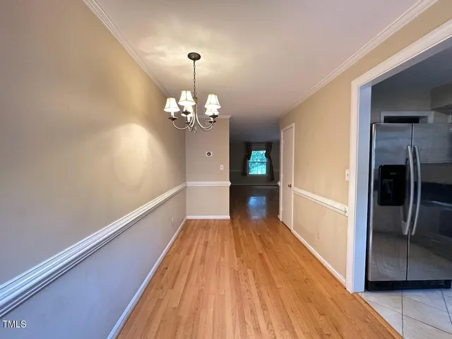 a view of a bedroom with wooden floor