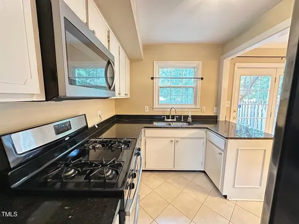 a kitchen with a stove and a sink