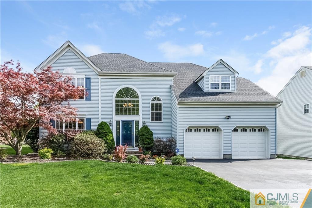 437 Vanderveer Road Raritan, NJ 08869 - Photo 2 of 25 a front view of a house with a yard and garage