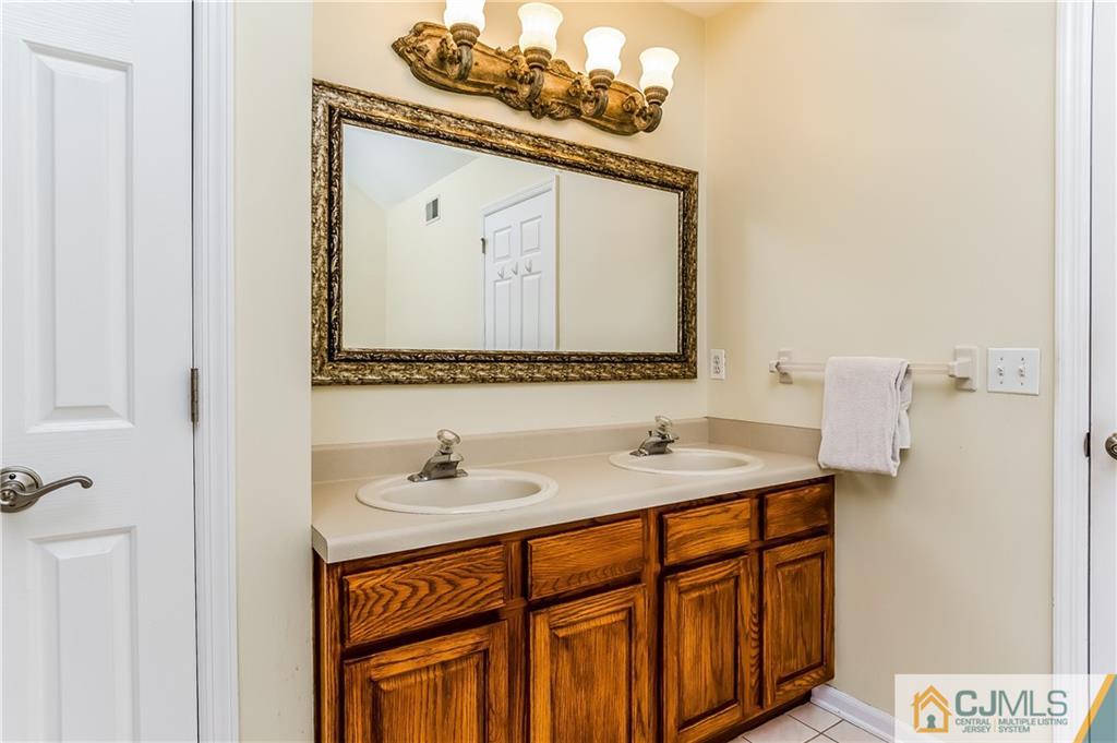 437 Vanderveer Road Raritan, NJ 08869 - Photo 14 of 25 a bathroom with a sink vanity and a mirror