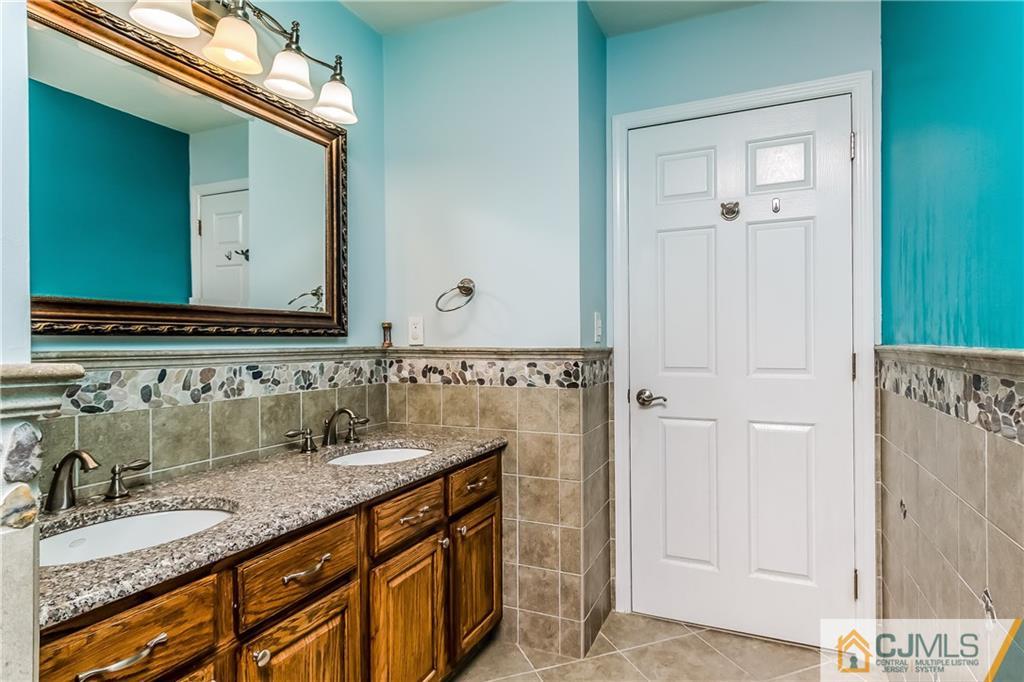 437 Vanderveer Road Raritan, NJ 08869 - Photo 19 of 25 a bathroom with a granite countertop sink and a mirror