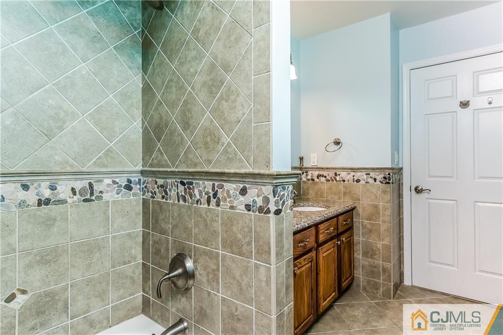 437 Vanderveer Road Raritan, NJ 08869 - Photo 20 of 25 a bathroom with a granite countertop sink a mirror and shower